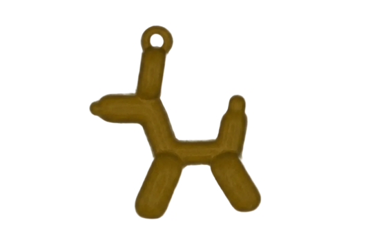 Close-up of a gold-tone balloon dog charm on a black background.