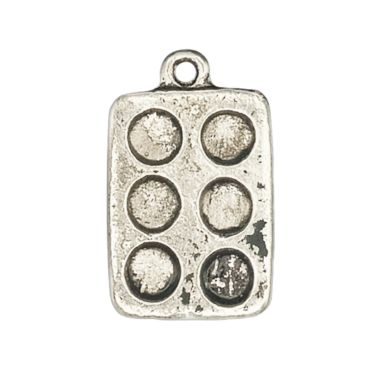 Close-up of a silver muffin pan charm with six round wells on a black background.