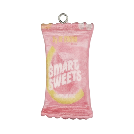 close-up of a pink candy bag charm with 'SMART SWEETS' text on a black background