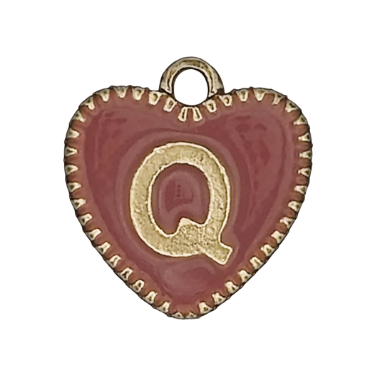 close-up of red heart charm with gold letter Q