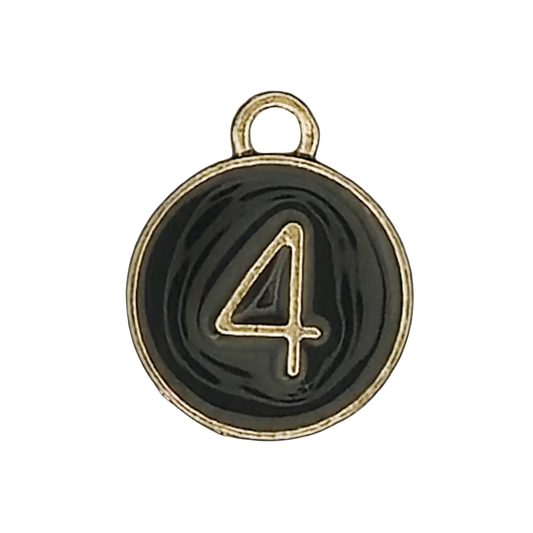 close-up of a round black charm with a gold number 4