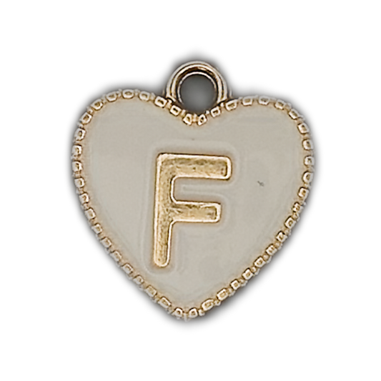 close-up of white enamel heart charm with gold letter F and beaded gold edge