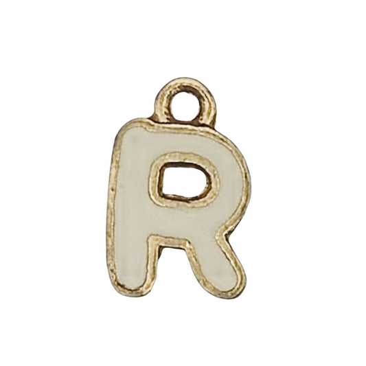 close-up of a white enamel letter R charm with gold-tone edge on black background