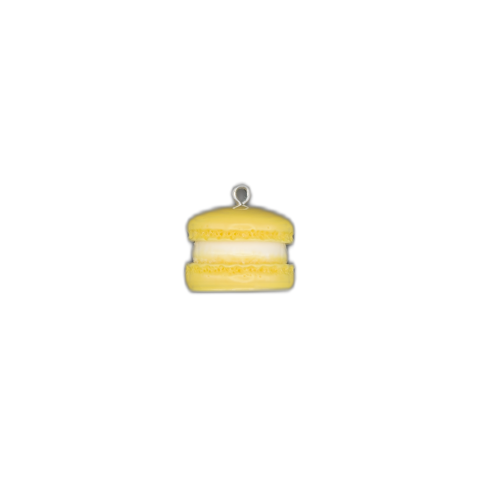 small yellow macaron charm centered on a black background