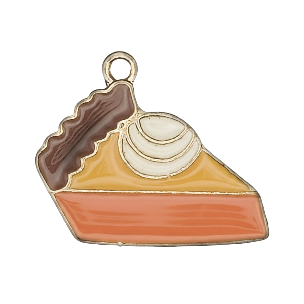 Close-up of enamel pie slice charm with whipped cream, orange filling, and brown crust.