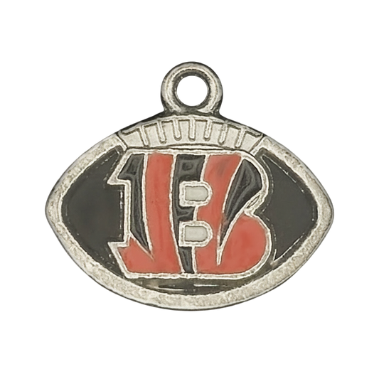 close-up of a football-shaped metal charm with an orange 'B' on black enamel