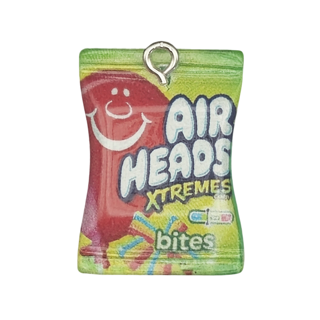 close-up of a miniature Airheads Xtremes Bites candy bag charm on a black background
