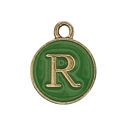 close-up of round green enamel charm with gold letter R
