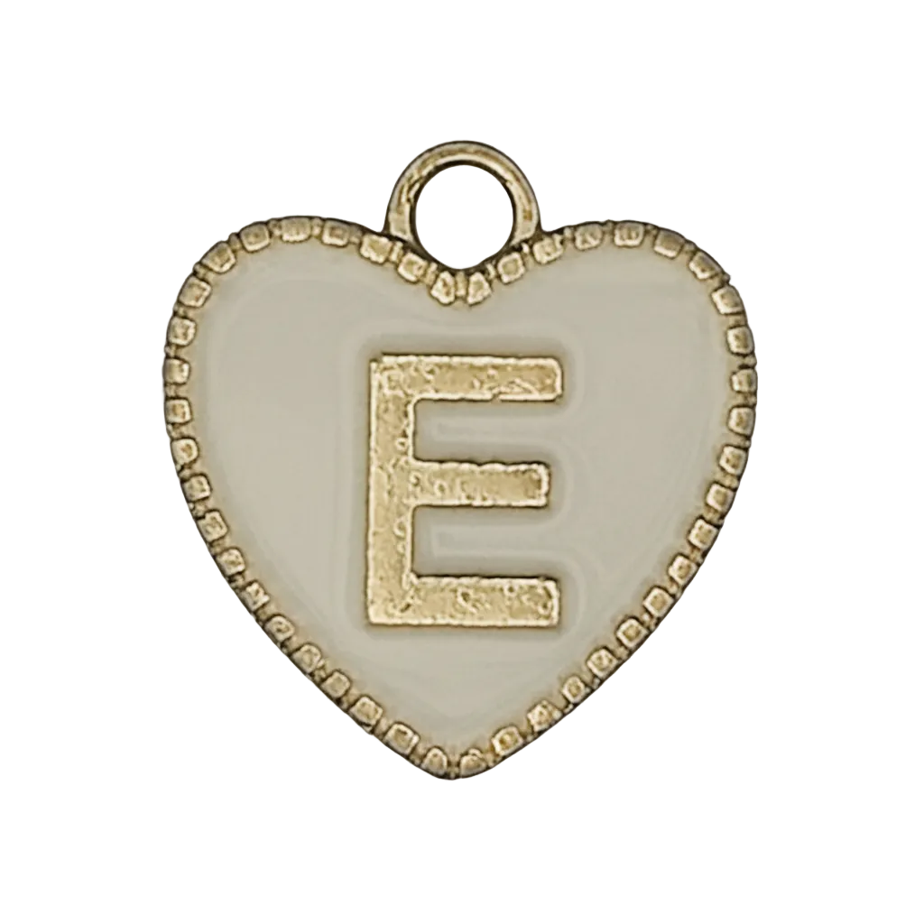 close-up of heart-shaped charm with gold letter E on white