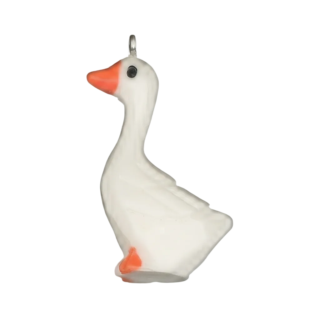 close-up of a white goose charm with an orange beak on a black background
