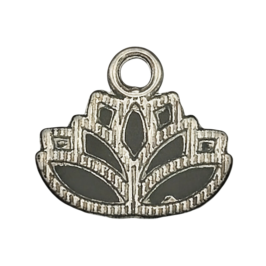 close-up of a small silver lotus flower charm with etched details on a black background