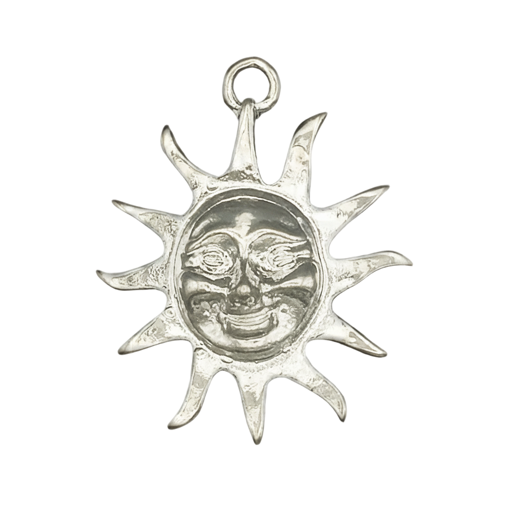 close-up silver sun face charm with pointed rays on black background