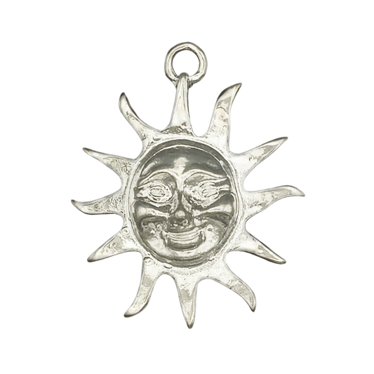 close-up silver sun face charm with pointed rays on black background