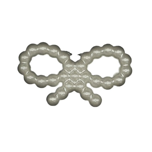 close-up of small pearl beaded bow charm on black background