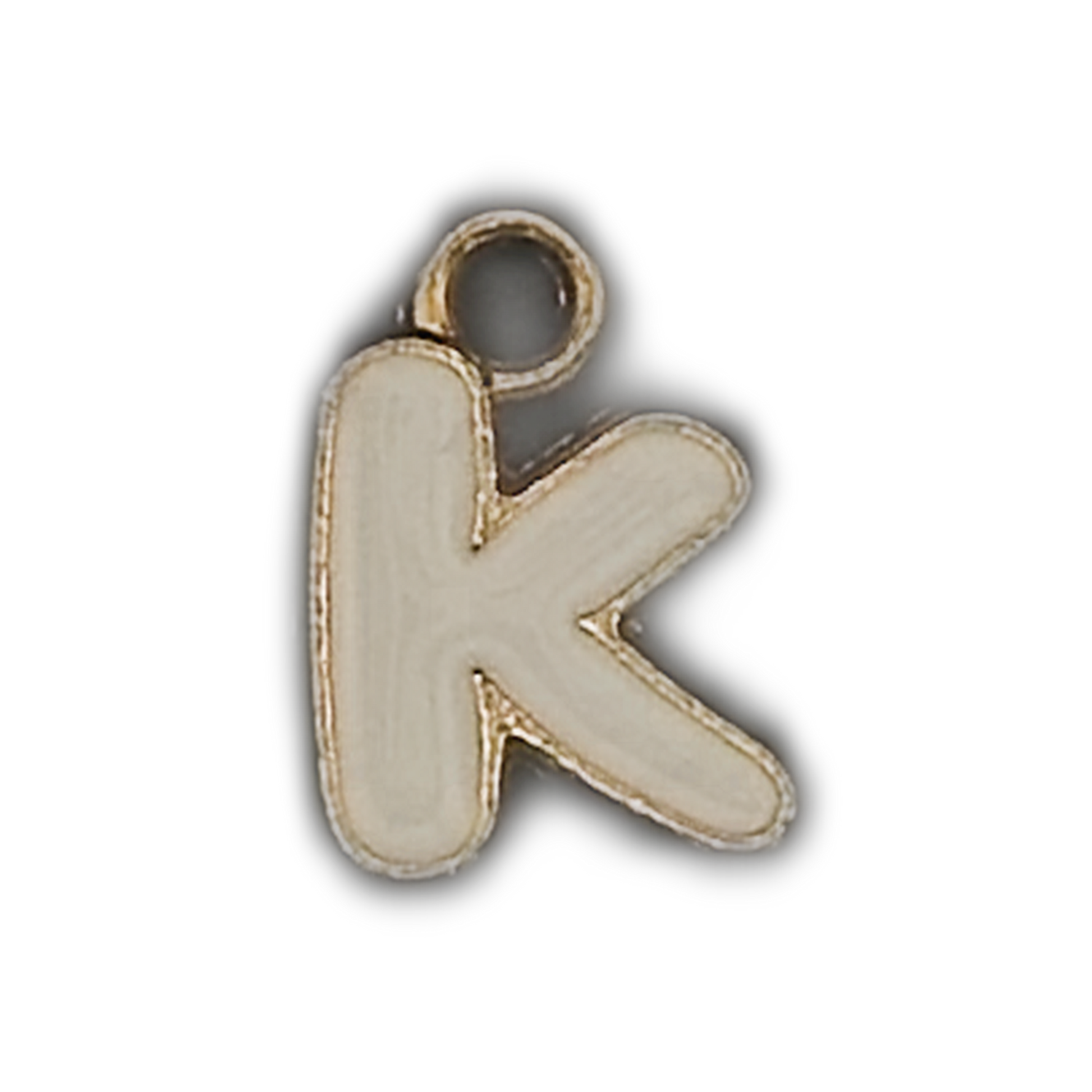 Close-up of a small white enamel lowercase letter k charm with a gold outline on a black background.