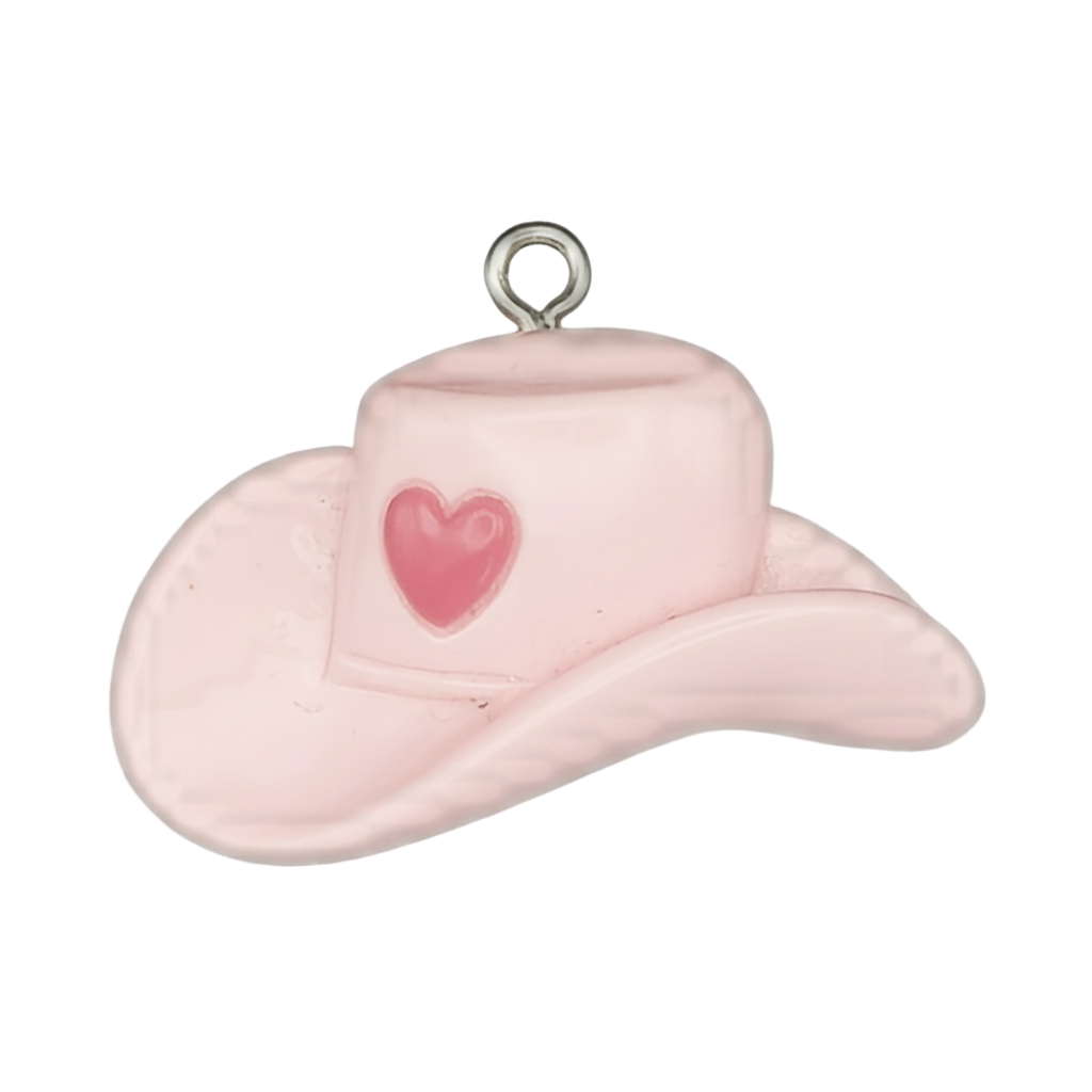 close-up pink cowboy hat charm with heart on crown, black background