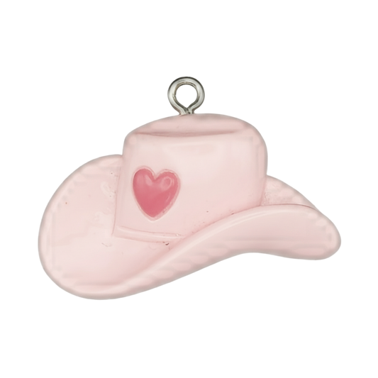 close-up pink cowboy hat charm with heart on crown, black background