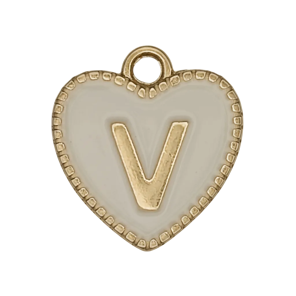 close-up of white heart charm with gold letter V
