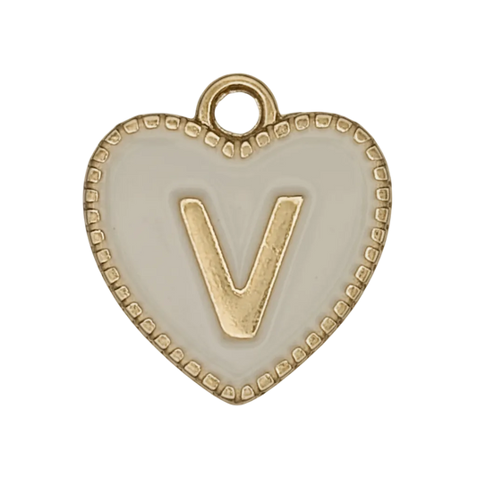 close-up of white heart charm with gold letter V