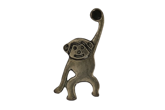 close-up bronze monkey charm with one arm raised on black background
