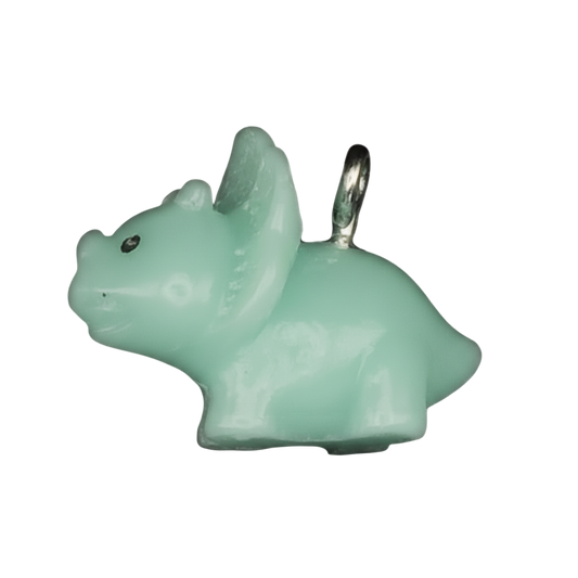 close-up of a mint green triceratops charm on a black background