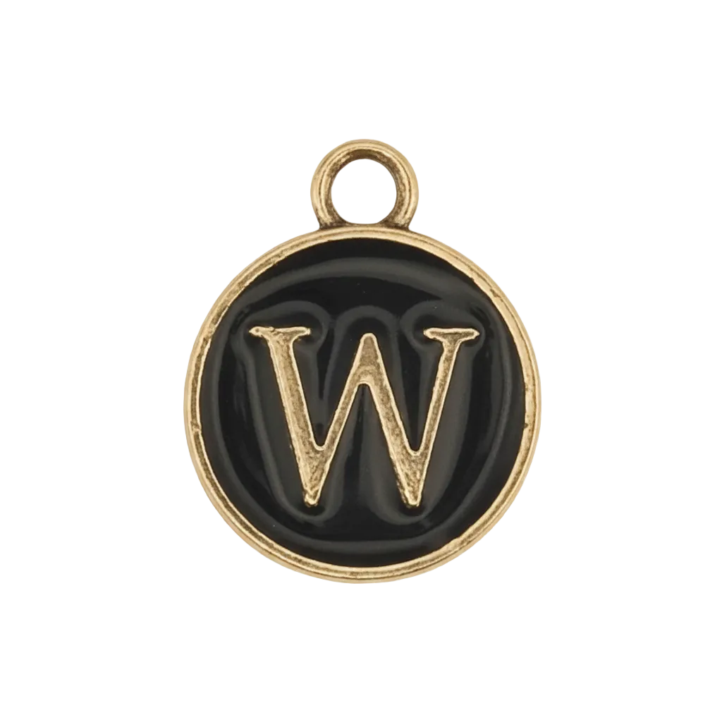 close-up of round black enamel charm with gold letter W