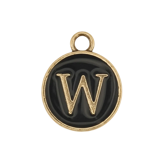close-up of round black enamel charm with gold letter W