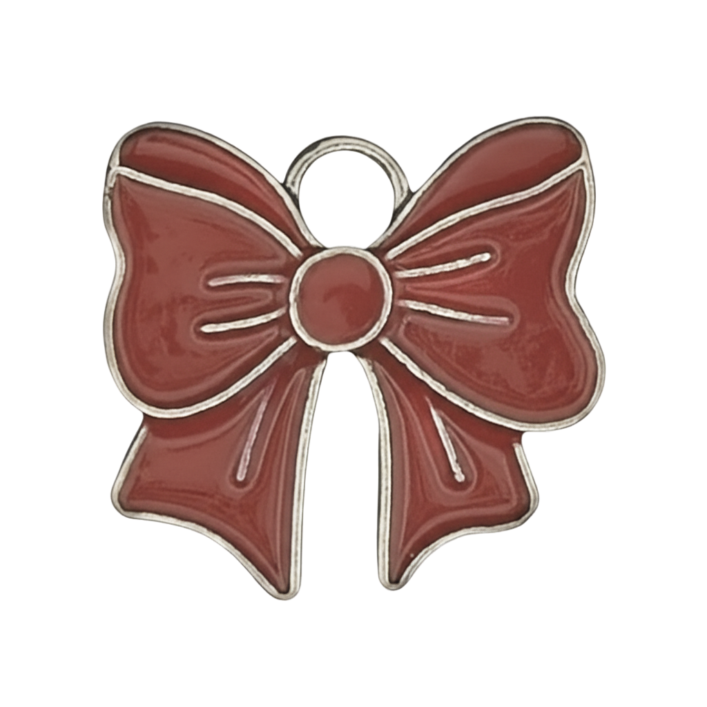 close-up of a red enamel bow charm with silver outline on black background