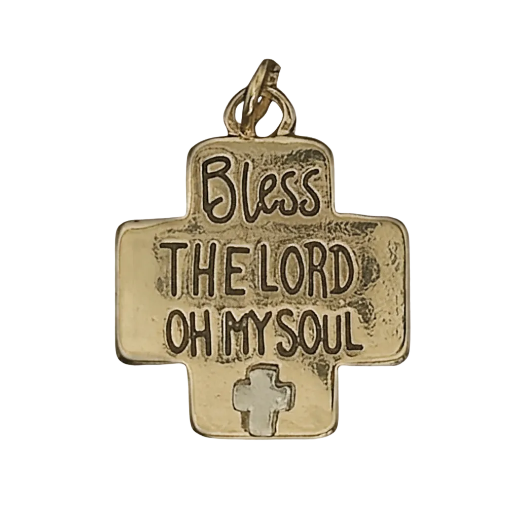 close-up of gold cross-shaped charm reading 'Bless the Lord Oh My Soul' with small cross detail on black background
