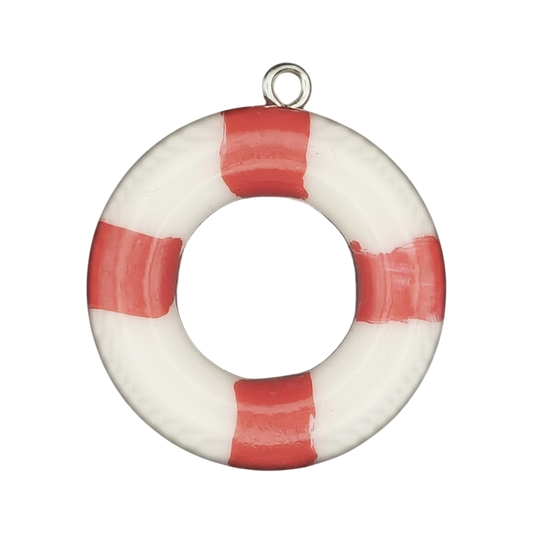 close-up of red and white lifebuoy charm with dark center on black background