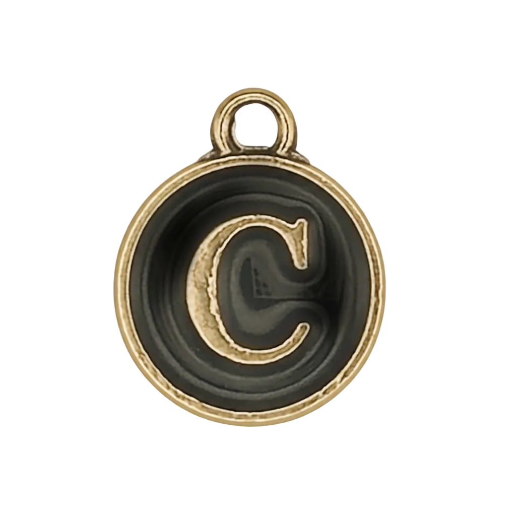 close-up of round black and gold letter C charm
