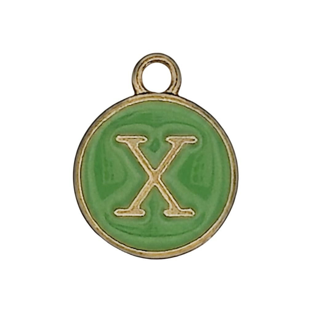 Close-up of round green enamel charm with gold letter X.