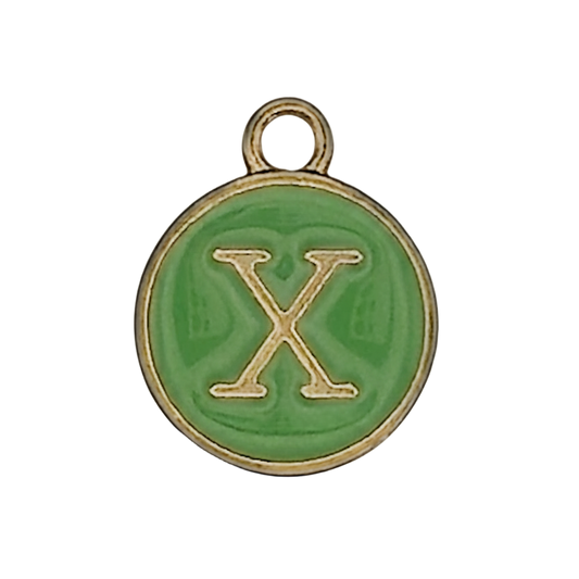 Close-up of round green enamel charm with gold letter X.