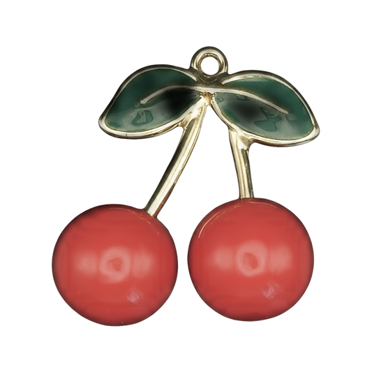 gold-tone cherry charm with two red cherries and green leaves on a black background