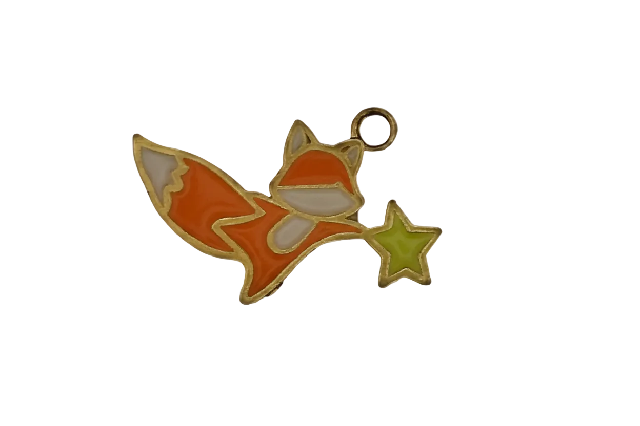 orange fox enamel charm holding a green star on black background