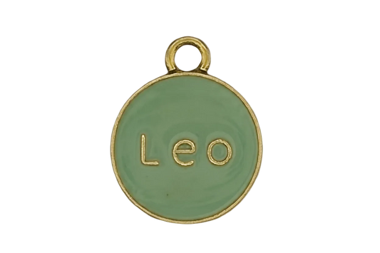 Close-up of round mint enamel charm with gold 'Leo' text and rim.