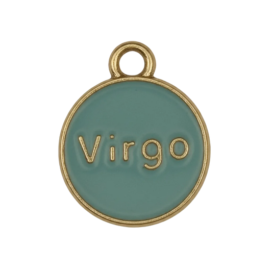 close-up of round teal Virgo charm with gold-tone rim on black background