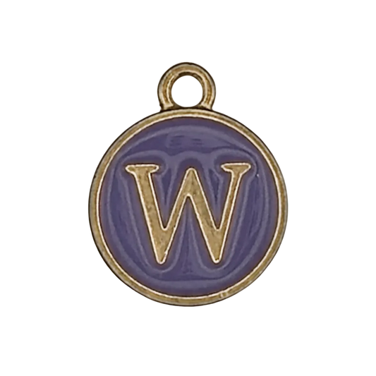 close-up of round purple enamel charm with gold letter W on black background