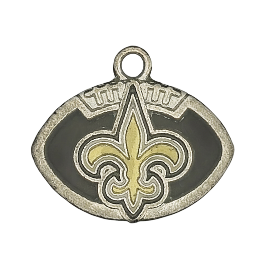 close-up of silver football-shaped charm with black enamel and a gold fleur-de-lis
