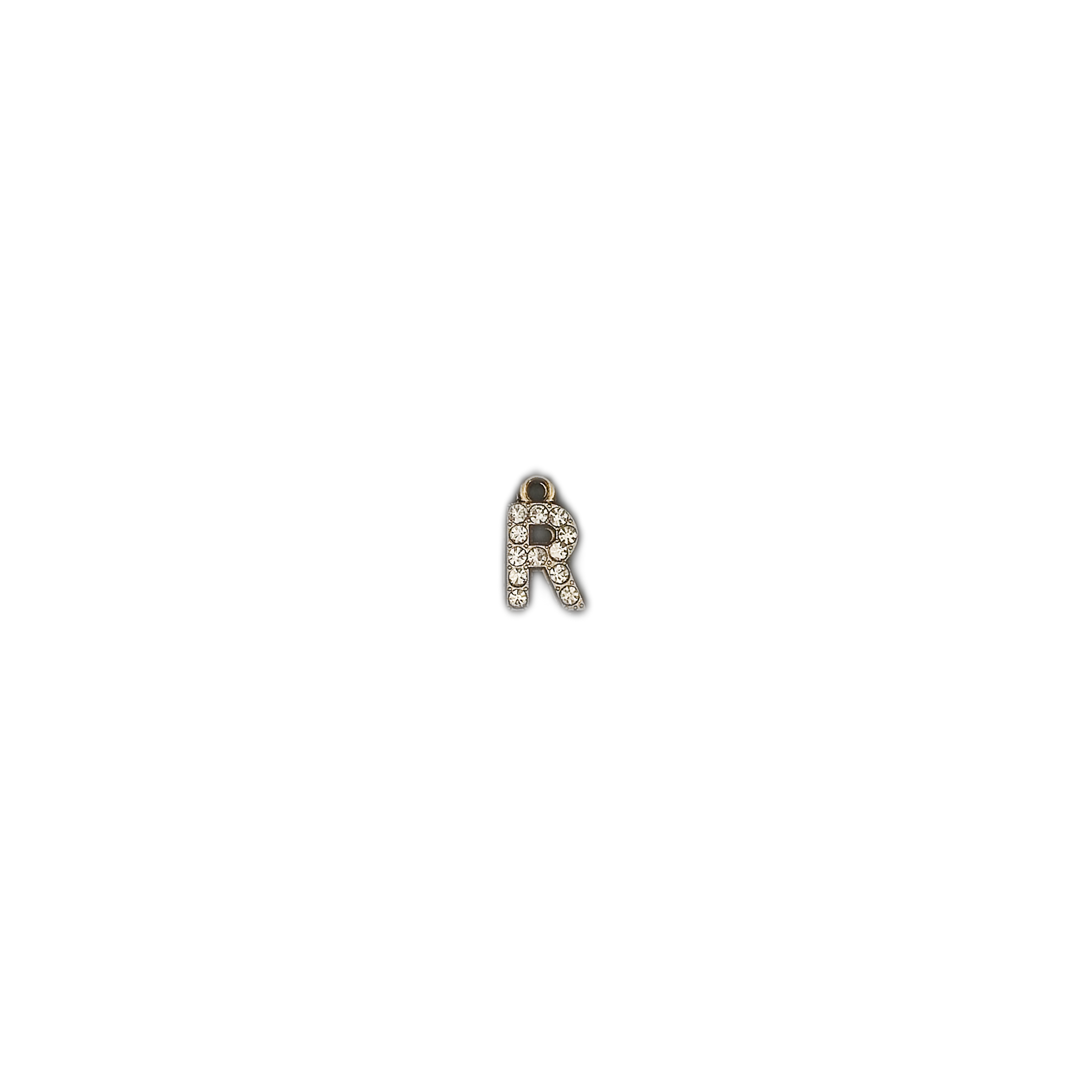 small gold-tone letter R charm with clear crystals on a black background