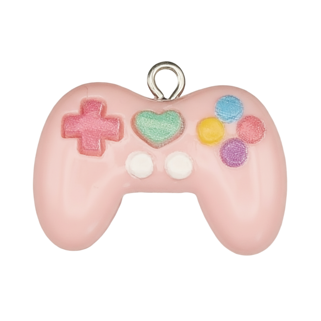 close-up of a pink game controller charm with multicolor buttons on a black background