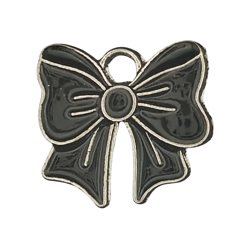 close-up of a small black enamel bow charm with silver outline on a black background
