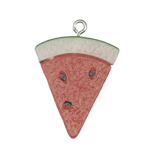 close-up of a watermelon slice enamel charm on a black background