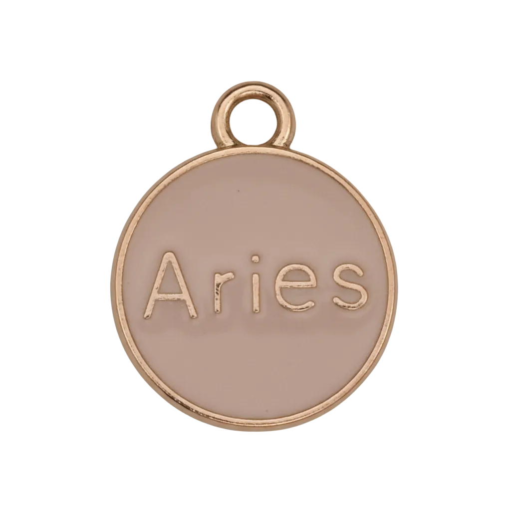 close-up of round pink enamel charm with gold edge reading Aries on a black background