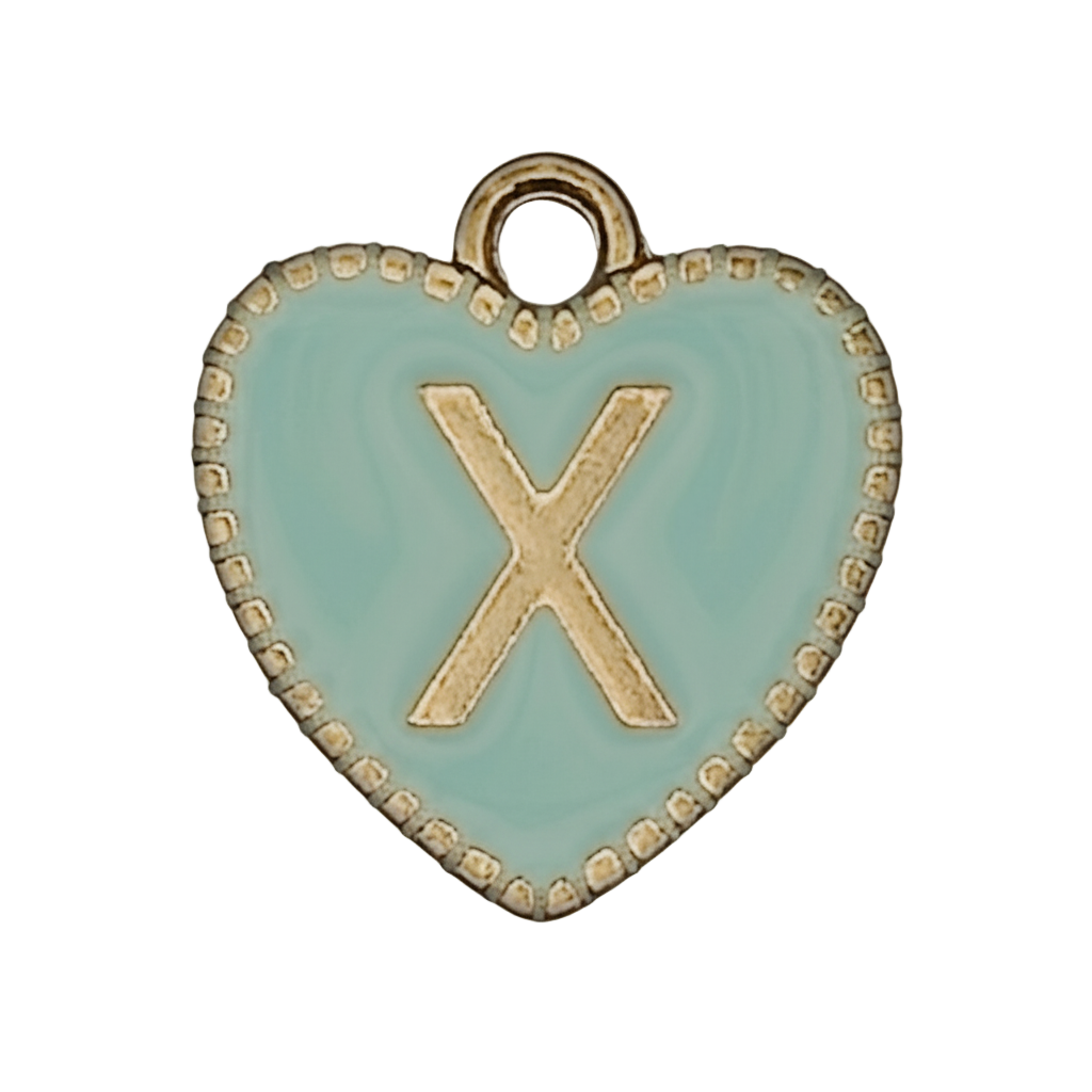 close-up of mint enamel heart charm with gold letter X and beaded edge on black background