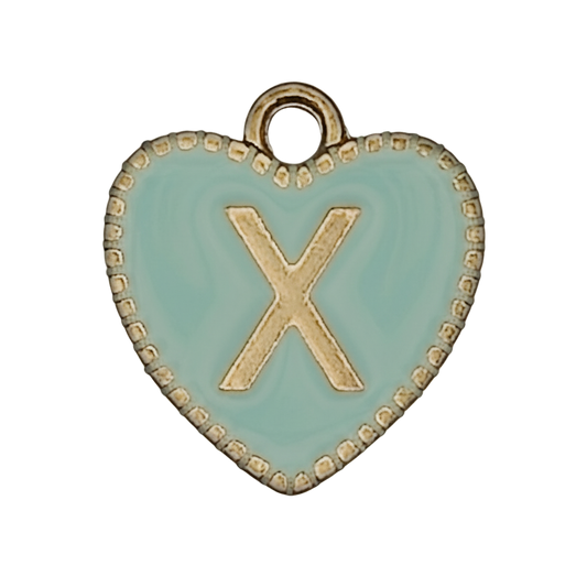 close-up of mint enamel heart charm with gold letter X and beaded edge on black background