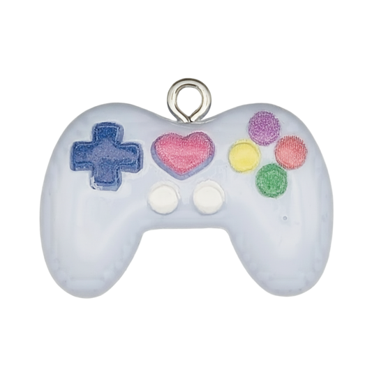 close-up of white game controller charm with colorful buttons