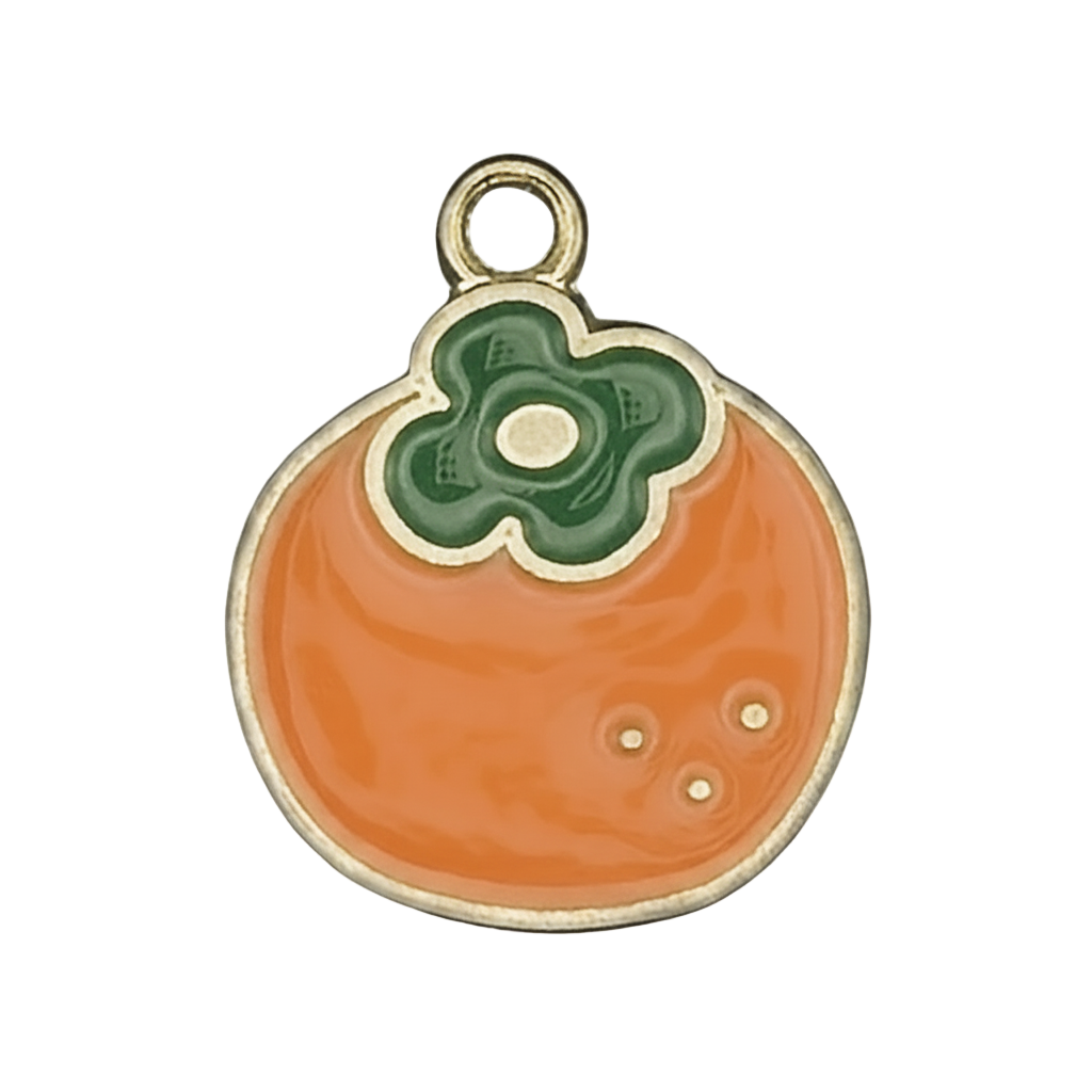 close-up of orange persimmon enamel charm with green top on black background