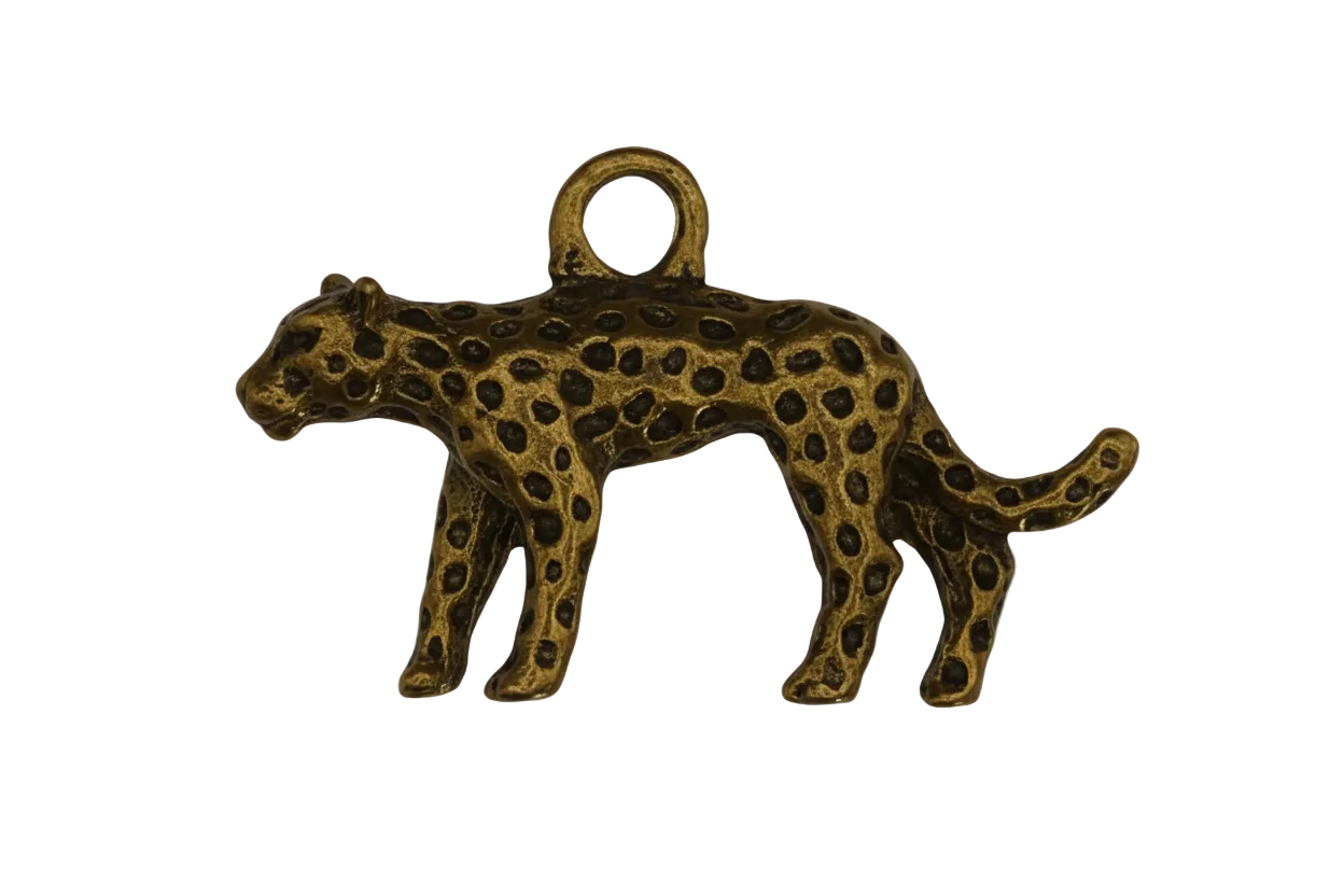 close-up of small gold spotted leopard charm on black background