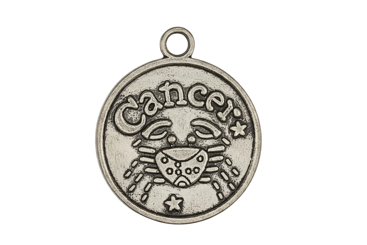 Close-up of round silver-tone Cancer zodiac charm with crab design on black background.